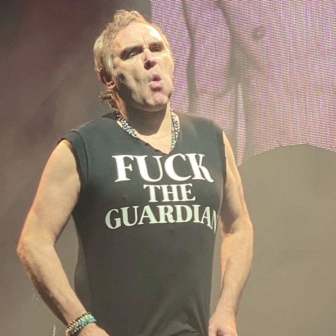 Morrissey selling autographed copies of OTHER artists’ LPs & “Fuck the Guardian” t-shirts at shows