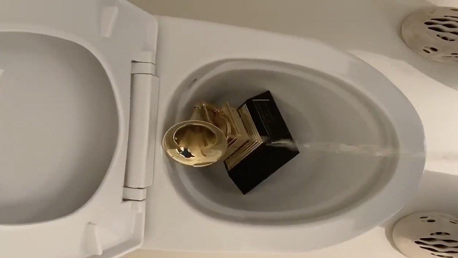 Kanye West tweets video of himself pissing on a Grammy